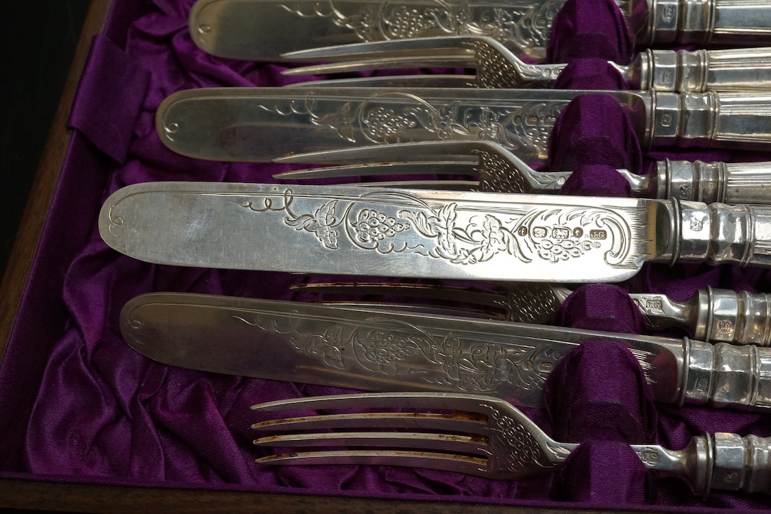 Twelve pairs of Victorian silver King's pattern dessert eaters, by John Gilbert, Birmingham, 1879/1880, loaded handles, in a mahogany canteen.